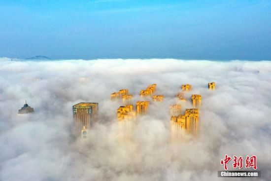 6月2日，山东省日照市东港区沿海出现平流雾景观，从海上飘来的雾气飘飘渺渺，上空俯瞰海滨城市宛如仙境。（无人机照片）